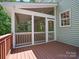 Angle of screened in porch showing the exterior, wooden deck, and siding at 1708 Meadow Crest Ct, Matthews, NC 28104