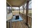 Back porch view with table, blue patterned rug, and neighborhood street at 1806 Little Rock Rd, Charlotte, NC 28214