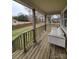 Cozy back porch with white sofa, wooden deck and view of the backyard at 1806 Little Rock Rd, Charlotte, NC 28214