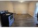 Dining room with vinyl flooring and natural light streaming in from outside, adjacent to the kitchen appliances at 1806 Little Rock Rd, Charlotte, NC 28214