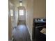 Hallway showcasing durable floors that extend into a kitchen with appliances and an exit door at 1806 Little Rock Rd, Charlotte, NC 28214