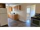 Functional kitchen featuring wooden cabinets, laminate countertops, a refrigerator, and open access to the dining area at 1806 Little Rock Rd, Charlotte, NC 28214