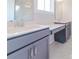 Elegant bathroom featuring double sinks, a vanity area, and marble-look tile at 210 Gilead Rd, Huntersville, NC 28078
