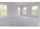 Bright, airy bedroom with plush carpet and three large windows at 210 Gilead Rd, Huntersville, NC 28078