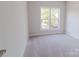 Bright bedroom featuring neutral carpet and a large window with natural light at 210 Gilead Rd, Huntersville, NC 28078