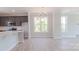 Bright dining area next to the kitchen with big windows and modern light fixture at 210 Gilead Rd, Huntersville, NC 28078