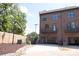 Brick townhome featuring an attached garage, balcony, and landscaped yard at 210 Gilead Rd, Huntersville, NC 28078