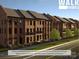 Three-story brick townhomes with rear balconies and front fenced courtyards at 210 Gilead Rd, Huntersville, NC 28078