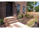 Stylish brick facade with manicured landscaping, and entry steps at 210 Gilead Rd, Huntersville, NC 28078