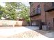 Brick townhome featuring an attached garage, balcony, and landscaped yard at 210 Gilead Rd, Huntersville, NC 28078