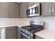 A chef's kitchen with quartz counters and stainless steel gas range at 210 Gilead Rd, Huntersville, NC 28078