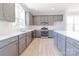 Modern kitchen features gray cabinets, stainless appliances, and white countertops at 210 Gilead Rd, Huntersville, NC 28078