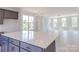 Open living space featuring hardwood floors and large windows at 210 Gilead Rd, Huntersville, NC 28078