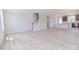 Spacious living room featuring sleek flooring, stairs and a modern chandelier at 210 Gilead Rd, Huntersville, NC 28078