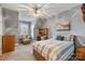 Cozy bedroom with neutral walls, a comfortable bed, a ceiling fan, and natural light from the window at 2379 Metcalf Dr, Sherrills Ford, NC 28673