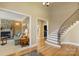 Foyer with hardwood floors, curved staircase, and views into the living room with a stone fireplace at 2379 Metcalf Dr, Sherrills Ford, NC 28673