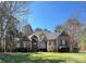 Brick and stone home with manicured lawn, mature trees, and a charming entrance at 2379 Metcalf Dr, Sherrills Ford, NC 28673