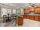 Well-lit kitchen featuring custom wood cabinetry, granite countertops, stainless steel appliances, and a cozy breakfast nook at 2379 Metcalf Dr, Sherrills Ford, NC 28673