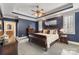 Spacious main bedroom with a trey ceiling, dark blue walls, and plush carpet at 2379 Metcalf Dr, Sherrills Ford, NC 28673