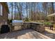 Backyard outdoor kitchen with a stainless steel grill, stone countertops, and lush landscaping at 2379 Metcalf Dr, Sherrills Ford, NC 28673