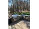 A well-equipped outdoor kitchen with stone accents and stainless steel appliances at 2379 Metcalf Dr, Sherrills Ford, NC 28673