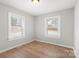 Bright bedroom with natural light and wood-look flooring at 2407 Moose Rd, Kannapolis, NC 28083