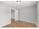 Neutral bedroom with wood-look floors, door, and a window at 2407 Moose Rd, Kannapolis, NC 28083