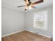 Well lit bedroom featuring modern ceiling fan, window, and wood-look floors at 2407 Moose Rd, Kannapolis, NC 28083