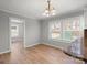 Bright dining area with hardwood floors, modern lighting, and large windows at 2407 Moose Rd, Kannapolis, NC 28083