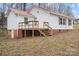 Charming house featuring a red metal roof, brick foundation, and a wooden porch at 2407 Moose Rd, Kannapolis, NC 28083