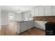 Open kitchen with white cabinets, granite countertops, and stainless steel sink at 2407 Moose Rd, Kannapolis, NC 28083