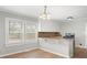 Bright kitchen with white cabinets, granite countertops, breakfast bar, and hardwood floors at 2407 Moose Rd, Kannapolis, NC 28083