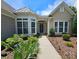 Charming single-story home with landscaped front yard and inviting entrance featuring large windows at 36112 Watsonia St, Fort Mill, SC 29707