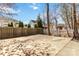 A fenced backyard featuring a basketball hoop and a concrete patio, perfect for outdoor activities at 3960 Franklin Meadows Dr, Matthews, NC 28105