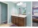 Bright bathroom with large mirror, single sink vanity, and linen closet at 3960 Franklin Meadows Dr, Matthews, NC 28105