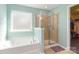 Bathroom featuring a soaking tub, glass-enclosed shower, and window at 3960 Franklin Meadows Dr, Matthews, NC 28105