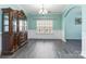 Elegant dining room with modern hardwood floors, wainscoting, and a large window for natural light at 3960 Franklin Meadows Dr, Matthews, NC 28105