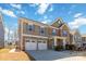 A two-story home with a two-car garage, brick accents, and a well-manicured lawn on a sunny day at 3960 Franklin Meadows Dr, Matthews, NC 28105