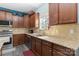 Well-lit kitchen with granite countertops, wood cabinets, and stainless steel appliances at 3960 Franklin Meadows Dr, Matthews, NC 28105