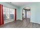 Bright, airy living room showcasing neutral paint, a large window, and hardwood floors, flowing into the entry foyer at 3960 Franklin Meadows Dr, Matthews, NC 28105