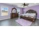 Spacious main bedroom with wood furniture, wood-style flooring, and a ceiling fan at 3960 Franklin Meadows Dr, Matthews, NC 28105