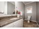 Half bathroom featuring a granite countertop, white cabinets and framed mirror at 4907 White Oak Ln, Denver, NC 28037