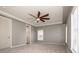 Spacious bedroom showcasing soft carpet, white trim, a ceiling fan and plenty of natural light at 4907 White Oak Ln, Denver, NC 28037