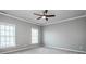 Spacious bedroom featuring a ceiling fan, neutral walls, and plush carpeting at 4907 White Oak Ln, Denver, NC 28037