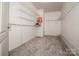 Walk-in closet with carpet flooring and metal shelving for ample storage at 4907 White Oak Ln, Denver, NC 28037