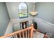 Second floor view of the home's entryway showing stairs, chandelier, large window with lake views at 4907 White Oak Ln, Denver, NC 28037