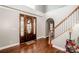 A bright foyer features hardwood floors, staircase, and neutral colors, showcasing a welcoming entrance at 4907 White Oak Ln, Denver, NC 28037