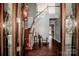 An elegant foyer features hardwood floors, staircase, and neutral colors, showcasing a welcoming entrance at 4907 White Oak Ln, Denver, NC 28037