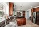 A modern kitchen features tile floors, wood cabinets, granite counters, and stainless steel appliances at 4907 White Oak Ln, Denver, NC 28037