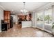 Bright kitchen featuring stainless steel appliances, tile floors, wooden cabinets, and backyard access at 4907 White Oak Ln, Denver, NC 28037